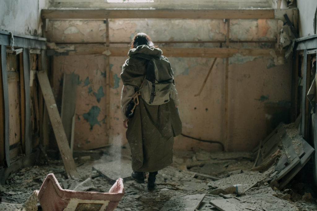 a person standing in a destroyed room