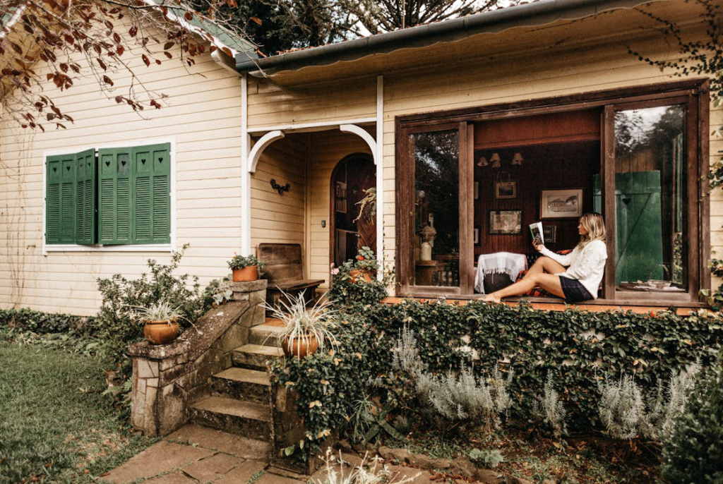 A person reading a fiction book on their patio